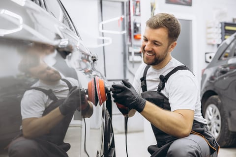 Man polishing car with professional auto polisher