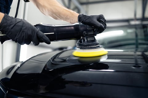 Close up of vehicle polisher tool rotating and polishing car hood