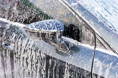 Car wash with foam and bubbles on windshield