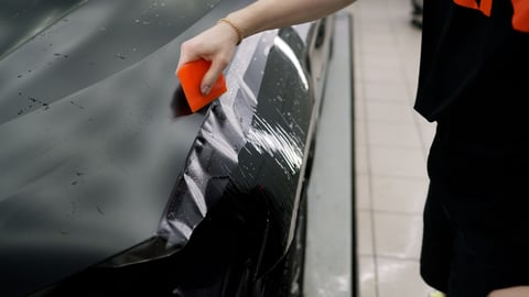 Applying transparent vinyl film to car hood