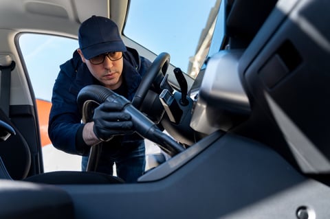 Car detailer cleaning vehicle dashboard