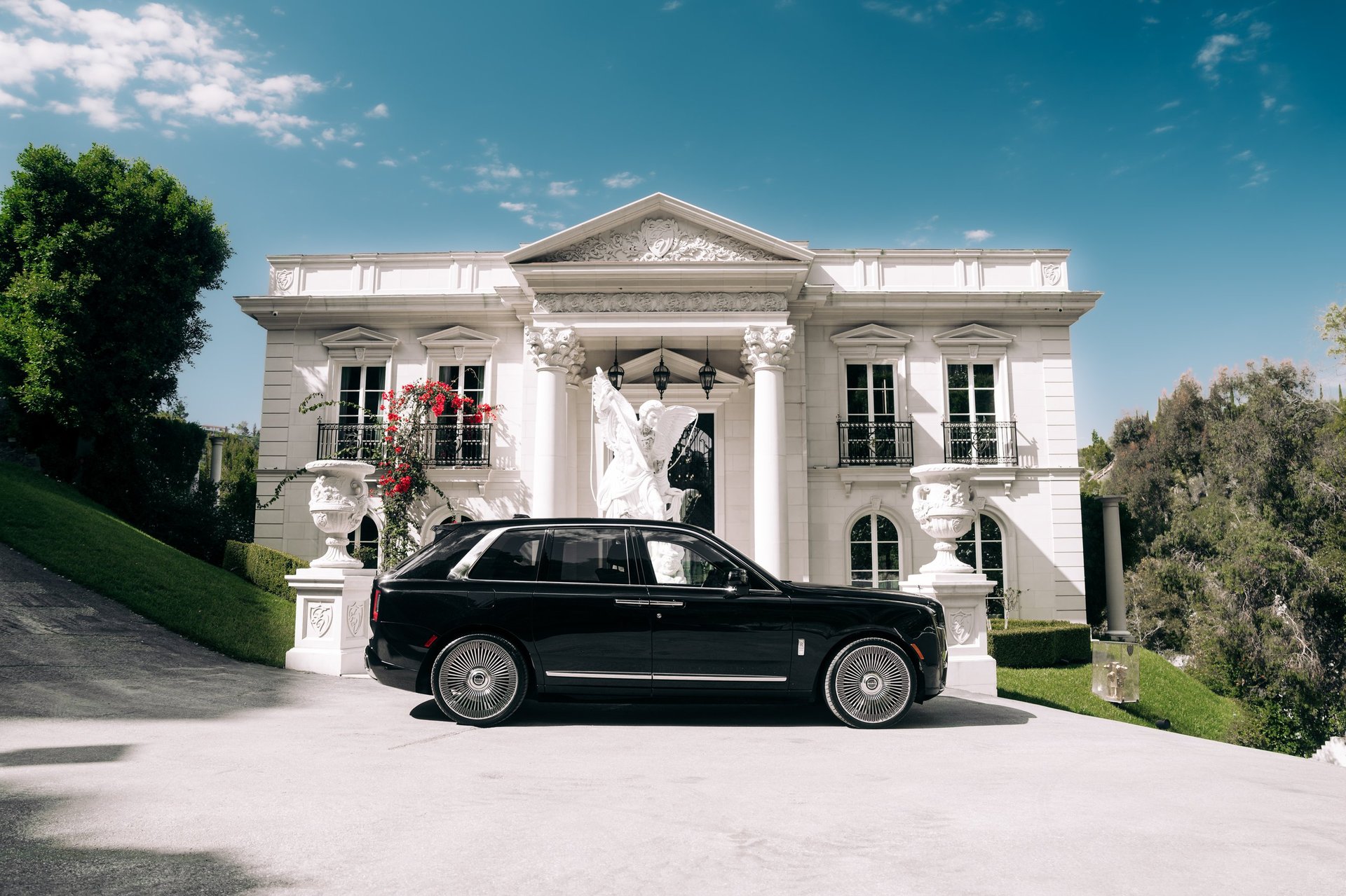 Black Rolls Royce Cullinan parked showing the passenger side of the car